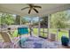 Cozy screened porch features a ceiling fan, comfortable seating, and view of the landscaped backyard at 104 Lancaster Ct, Goose Creek, SC 29445