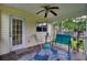 This screened porch features a ceiling fan, plenty of seating, and a view of the side yard at 104 Lancaster Ct, Goose Creek, SC 29445