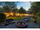 Spacious backyard featuring a fire pit, lounge seating, and lush landscaping at 108 E Walker Dr, Summerville, SC 29483