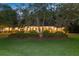 Beautiful brick home with a circular driveway and meticulously maintained landscaping at dusk at 108 E Walker Dr, Summerville, SC 29483