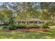 Beautiful brick home with a circular driveway and meticulously maintained landscaping at 108 E Walker Dr, Summerville, SC 29483