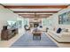 Comfortable living room with a fireplace, wood beams, and plenty of natural light at 108 E Walker Dr, Summerville, SC 29483
