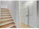 View of stairs with wood treads and white risers, and a white paneled wall with a door at 108 E Walker Dr, Summerville, SC 29483