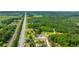 Expansive aerial view showcasing the neighborhood, lush greenery, and the property's peaceful country surroundings at 108 Wisteria Falls Ln, Saint Stephen, SC 29479