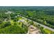 High angle aerial view showcases the neighborhood, main road, the property's peaceful and lush surroundings at 108 Wisteria Falls Ln, Saint Stephen, SC 29479