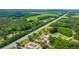 High angle aerial view showcases the neighborhood, main road, the property's peaceful and lush surroundings at 108 Wisteria Falls Ln, Saint Stephen, SC 29479