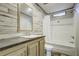 Well-lit bathroom with a tub and shower at 108 Wisteria Falls Ln, Saint Stephen, SC 29479