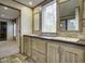 Bathroom with a double sink vanity and views into the adjacent bedroom at 108 Wisteria Falls Ln, Saint Stephen, SC 29479