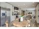 Spacious kitchen with stainless steel refrigerator, white cabinets, and an island that overlooks an open concept living area at 108 Wisteria Falls Ln, Saint Stephen, SC 29479