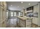 Spacious kitchen featuring an island with a wooden countertop and white cabinetry at 108 Wisteria Falls Ln, Saint Stephen, SC 29479