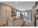 Bright kitchen with a large island, stainless steel sink, and wooden countertops at 108 Wisteria Falls Ln, Saint Stephen, SC 29479