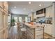 Modern kitchen featuring a spacious island with bar seating, stainless steel appliances, and natural light at 108 Wisteria Falls Ln, Saint Stephen, SC 29479