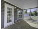 Inviting covered porch showcasing wood flooring, white railing, and a view of the surrounding neighborhood at 108 Wisteria Falls Ln, Saint Stephen, SC 29479