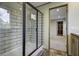 Modern shower with glass door and view into a bedroom at 108 Wisteria Falls Ln, Saint Stephen, SC 29479