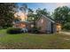 Backyard featuring a brick home, screened in porch and green lawn at 110 W 2Nd South St, Summerville, SC 29483