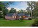 Backyard featuring a brick home, screened in porch and large trees at 110 W 2Nd South St, Summerville, SC 29483