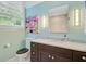 Bathroom features granite countertops, modern fixtures, and natural light from a large window at 110 W 2Nd South St, Summerville, SC 29483