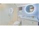 Modern bathroom featuring a sleek shower, toilet, and vanity with marble countertop and a round, illuminated mirror at 110 W 2Nd South St, Summerville, SC 29483