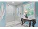 Modern bathroom featuring a spacious marble shower with glass door, adjacent to a decorative table with ornate details at 110 W 2Nd South St, Summerville, SC 29483