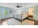 Charming bedroom with two windows, colorful rug, and iron bed frame at 110 W 2Nd South St, Summerville, SC 29483
