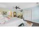 Bright bedroom with a bed, ceiling fan, and doorway to another room and bathroom at 110 W 2Nd South St, Summerville, SC 29483