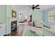 View from the living room into the bedroom and bathroom with fireplace and colorful rug at 110 W 2Nd South St, Summerville, SC 29483