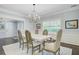 Bright dining room featuring a wooden table, stylish chairs, elegant chandelier, and a decorative area rug at 110 W 2Nd South St, Summerville, SC 29483
