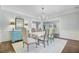 Stylish dining room with wainscoting, a modern chandelier, and ample seating, ideal for Gathering dinners and entertaining guests at 110 W 2Nd South St, Summerville, SC 29483