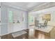 Welcoming entryway with hardwood floors, classic wainscoting, and views into the dining room, perfect for entertaining guests at 110 W 2Nd South St, Summerville, SC 29483