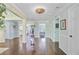 Elegant entryway featuring hardwood floors, detailed moldings, stylish lighting, and an open floor plan leading to other rooms at 110 W 2Nd South St, Summerville, SC 29483