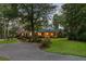 Charming brick home featuring a landscaped front yard, mature trees, and a welcoming entrance with a circular driveway at 110 W 2Nd South St, Summerville, SC 29483