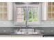 Close up of a kitchen sink and window showing the lovely backyard at 110 W 2Nd South St, Summerville, SC 29483