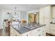Open-concept kitchen island and dining room with a seamless transition to the living room at 110 W 2Nd South St, Summerville, SC 29483