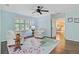 Bright living room featuring windows, arm chairs, and an entryway to the dining room at 110 W 2Nd South St, Summerville, SC 29483