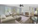 Cozy living room with a fireplace, comfortable sofas, and a ceiling fan at 110 W 2Nd South St, Summerville, SC 29483