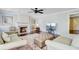 Comfortable living room with a fireplace, ceiling fan, and large ottoman on a decorative rug at 110 W 2Nd South St, Summerville, SC 29483