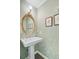 Charming powder room with decorative wallpaper, framed mirror, and pedestal sink at 110 W 2Nd South St, Summerville, SC 29483