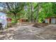 Spacious backyard with multiple storage sheds, mature trees, and a brick planter at 111 Circle Dr, Summerville, SC 29485