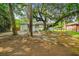 Shaded backyard featuring a brick house, mature trees, and green play set at 111 Circle Dr, Summerville, SC 29485
