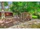 Backyard with chicken coop featuring chickens, mature trees, and concrete patio at 111 Circle Dr, Summerville, SC 29485