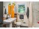 Traditional bathroom with a pedestal sink, wood shelving unit, and a shower with a curtain at 111 Circle Dr, Summerville, SC 29485
