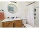 Updated bathroom features a modern vanity, round mirror, and a shower with a curtain at 111 Circle Dr, Summerville, SC 29485