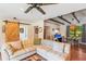 Inviting living room featuring hardwood floors, barn door, and open layout to the dining area at 111 Circle Dr, Summerville, SC 29485