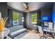 Modern office with gray walls, a futon, desk, and a neon 'GAME ROOM' sign at 111 Circle Dr, Summerville, SC 29485