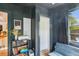 Gray-walled office space with a modern sofa, bookshelf, and plenty of natural light at 111 Circle Dr, Summerville, SC 29485