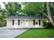 Charming single-story home showcasing a well-manicured lawn and a classic front door with a wreath at 1137 Dickson Ave, Hanahan, SC 29410