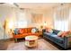 Sunlit living room with modern decor, hardwood floors, plush seating, and a decorative area rug at 1137 Dickson Ave, Hanahan, SC 29410