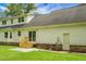 View of the backyard, brick-based stairs, and white siding from the lawn at 114 Heritage St, Summerville, SC 29485
