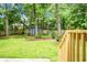 A spacious backyard with a shed, surrounded by a wooden fence and lush trees at 114 Heritage St, Summerville, SC 29485
