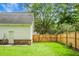 View of the backyard, brick-based steps, and white siding from the lawn at 114 Heritage St, Summerville, SC 29485